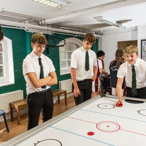 students playing air hockey