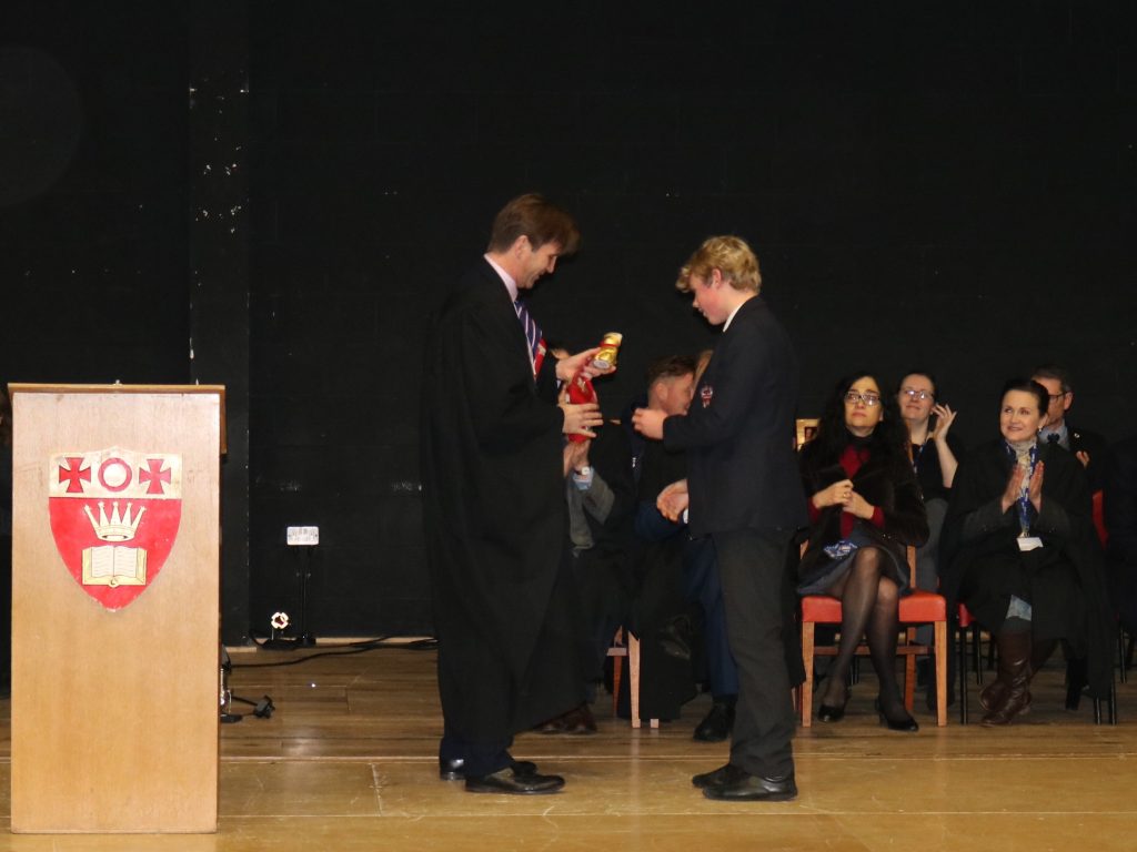 prep school student receiving award on stage