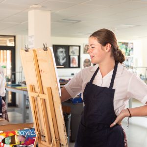 student painting onto a canvas