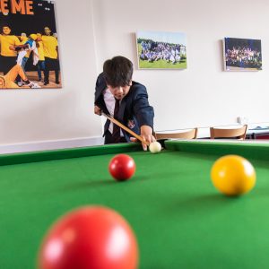 students in a game of pool
