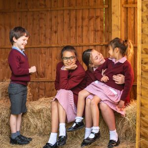 children sat in a barn