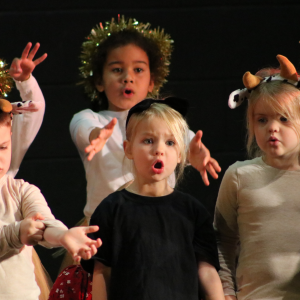 children singing in a production