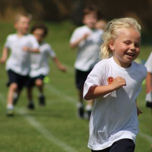 girl running across a pitch