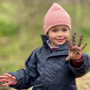 Girl with muddy hand