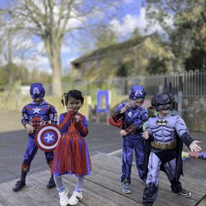 children dressed as superheroes