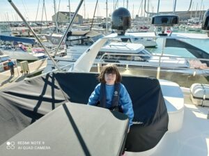 Schoolgirl on a boat in harbour