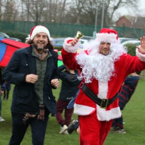 adult running with Father Christmas